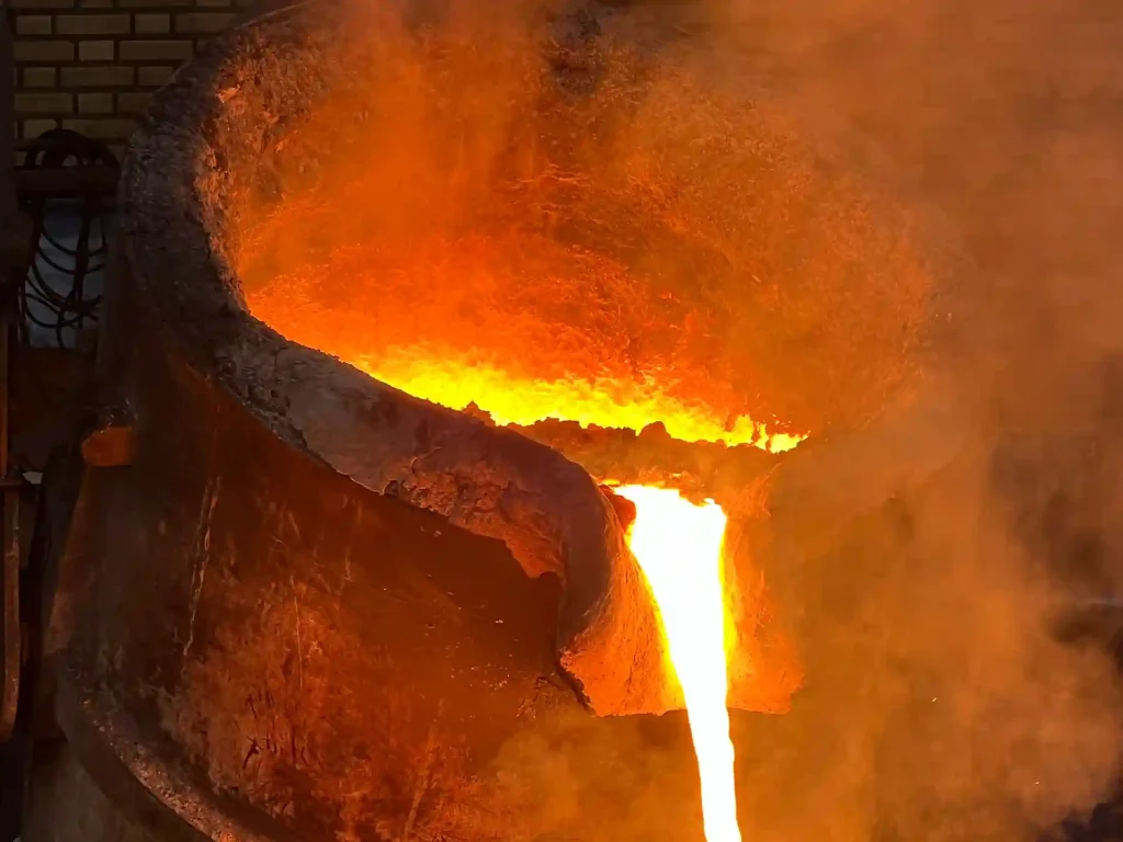 a molten metal pouring into a large container